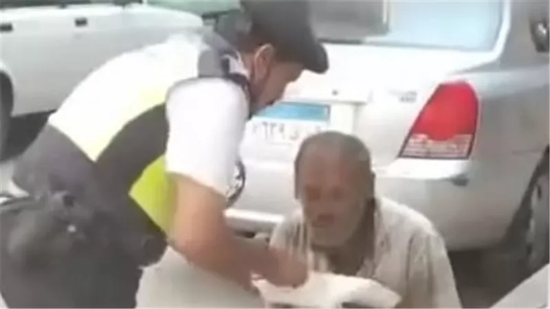 «الأمن مش قوة بس».. شرطي مصري يطعم رجلًا فقيرًا في الشارع بيده 